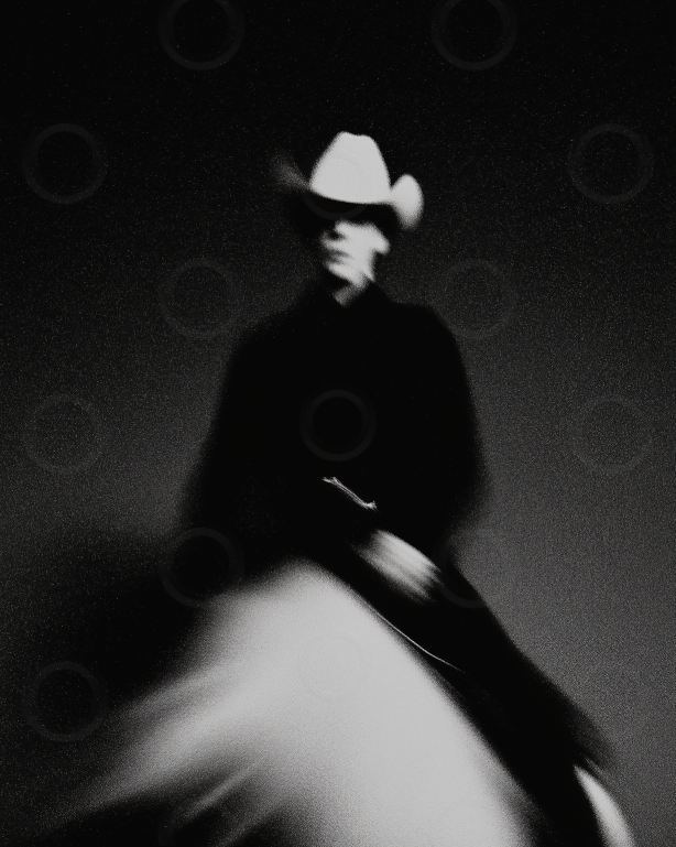 Monchrome cowboy riding a horse.