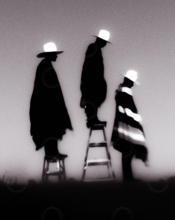 Monchrome cowboys on ladders beneath a fading sky.