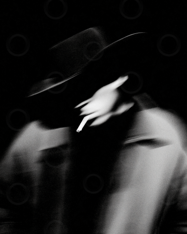 Monchrome blurred smoker in a wide brim hat.